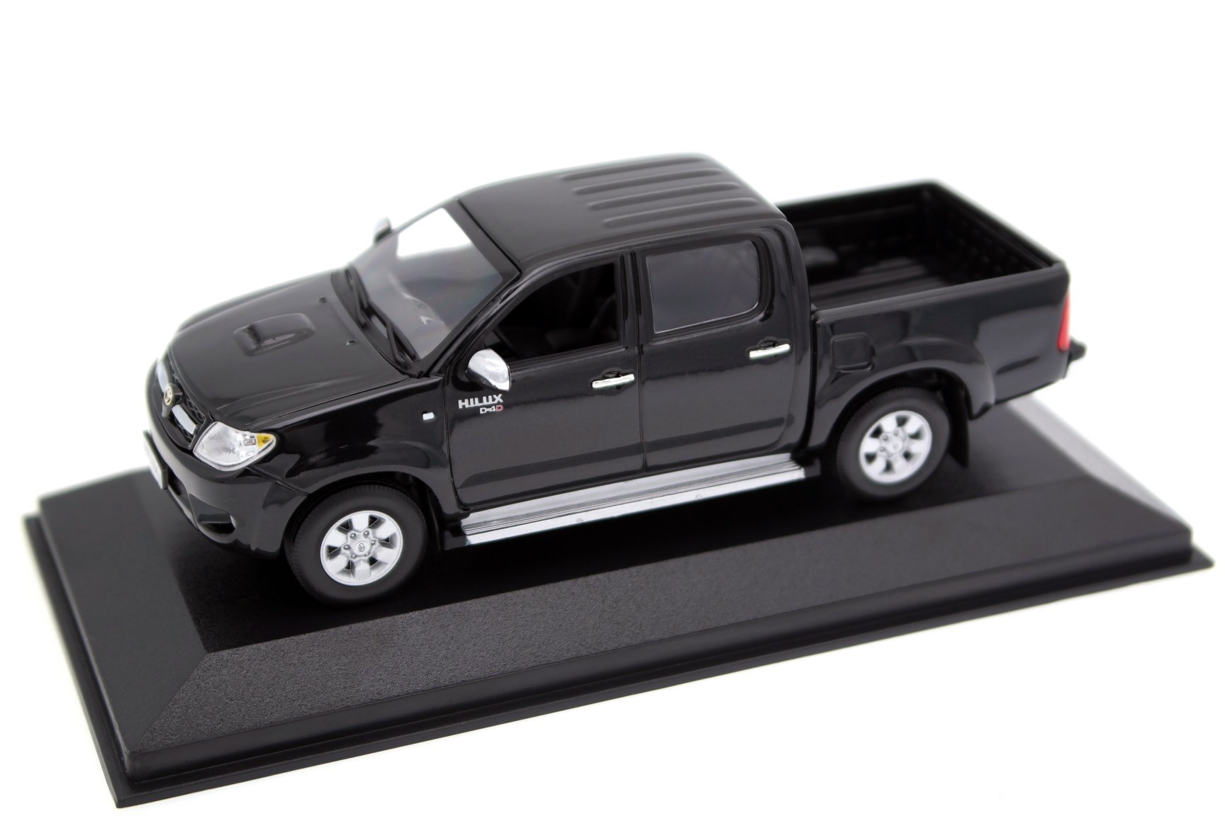 A collectible scale model Toyota Hilux from Minichamps