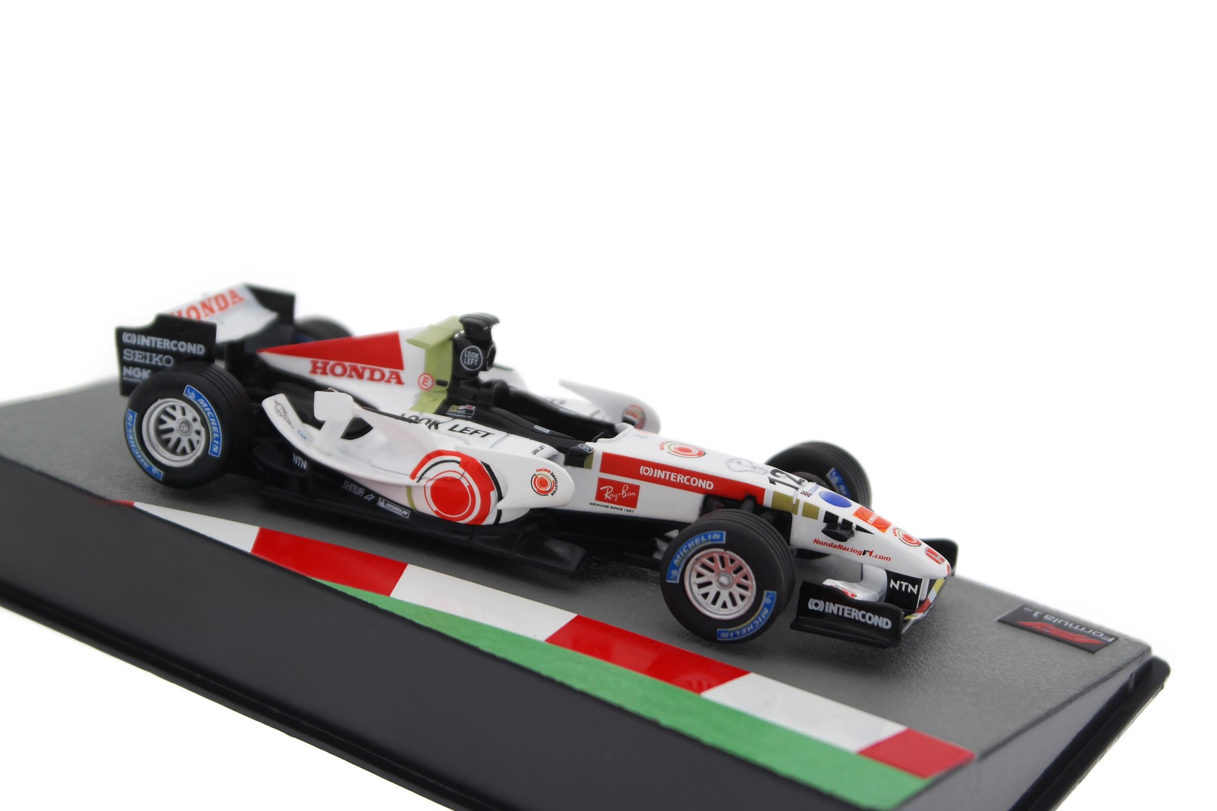 A collectible scale model Honda RA106 from Altaya F1